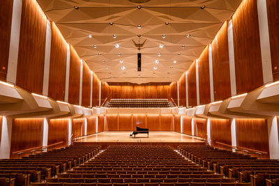 A large theater with a piano onstage