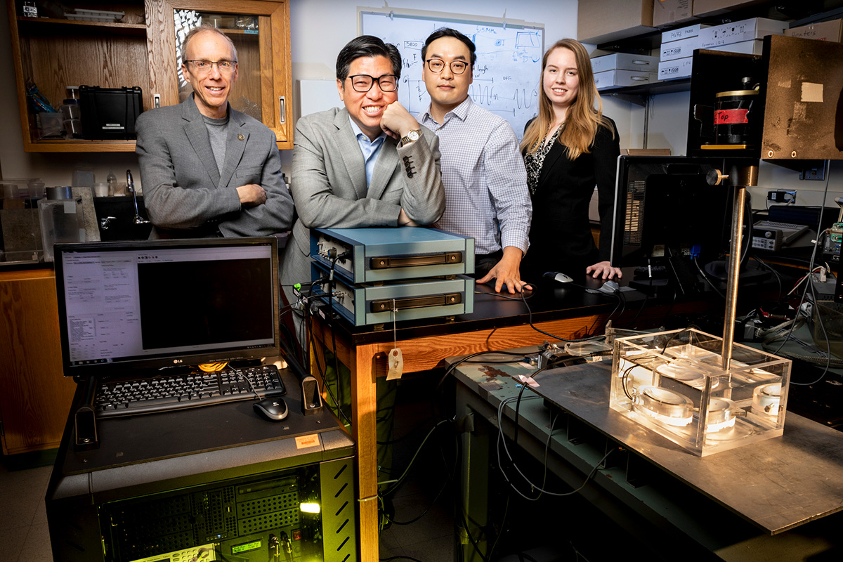 Jeffrey Moore, left, King Li, postdoctoral researcher Gun Kim and graduate student Abigail Halmes have collaborated to develop an ultrasound-activated synthetic molecule that can emit light deep inside biologic tissue for a variety of medical uses and therapies.