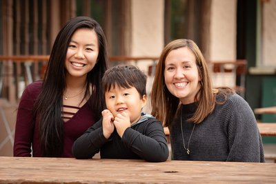 Photo of special education professor Meghan Burke, her son Rogan and Lily Ho, a senior in computer science