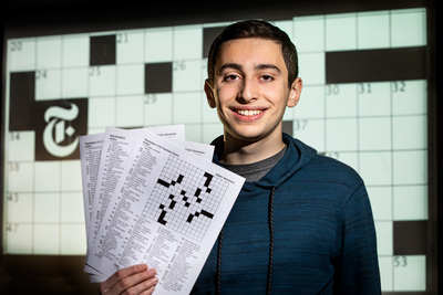 Adam Aaronson with some of his crossword puzzles