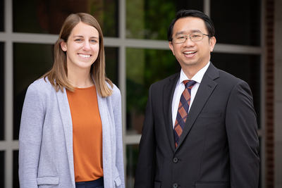 Social work professor Kevin Tan and alumna Jenna White standing outdoors