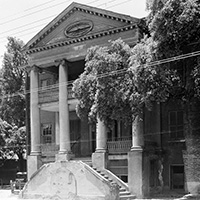 Black-and-white photo of a large, columned building.