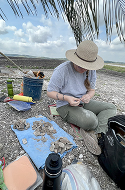 Graduate student Rachel Gill sorts artifacts to be collected and photographed.