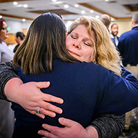 Exoneree Kristine Bunch receives a hug of support from a police recruit, one of several recruits who stopped to thank her for sharing her story.